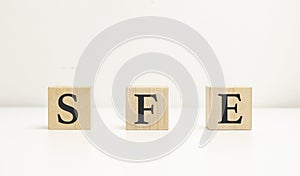 Concept image of Accounting Business Acronym SFE Sales Force Effectiveness written on white notebook