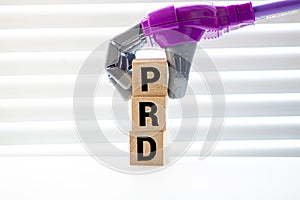 Concept image of Business Acronym PRD as Planning Research on wooden block
