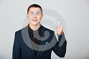 Concept image of a businessman holding bulb