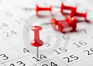 Concept image of a calendar with red push pins