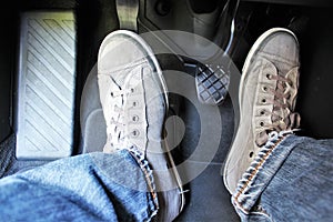 An concept image of a car pedal with jeans and foodware
