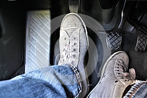 An concept image of a car pedal with jeans and foodware