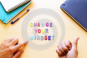 concept image with change your mindset text. top view of office table