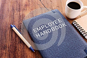 Concept image of employee handbook over wooden office table. top view