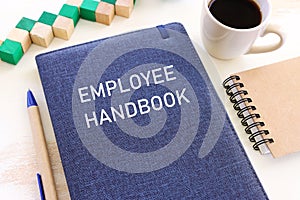 Concept image of employee handbook over wooden office table. top view