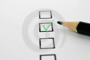 An concept Image of a green pencil and a questionnaire