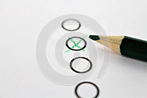 An concept Image of a green pencil and a questionnaire