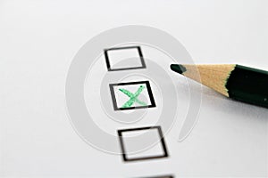 An concept Image of a green pencil and a questionnaire