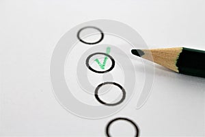 An concept Image of a green pencil and a questionnaire