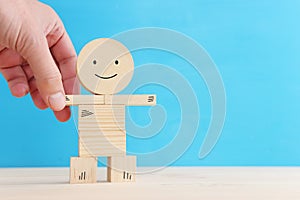 Concept image of happy mind and positive thinking. Wooden figure with smiling face