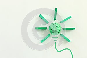 Concept image if green crumpled paper lightbulb, symbol of scr, innovation and eco friendly business