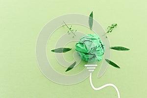 Concept image if green crumpled paper lightbulb, symbol of scr, innovation and eco friendly business