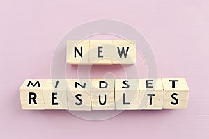concept image with new mindset new results text over wooden cubes