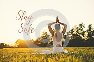 Concept image of woman doing yoga or meditation with text Stay Safe