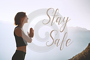 Concept image of woman doing yoga or meditation with text Stay Safe