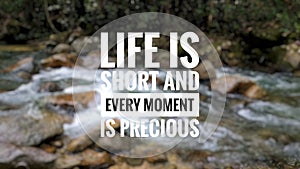 Concept image a word - LIFE IS SHORT AND EVERY MOMENT IS PRECIOUS with blur waterfall background