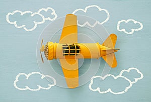 Concept of imagination, creativity, dreaming and childhood. Retro toy plane with info graphics sketch on the blue background