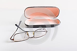 Concept of improper storage of old broken glasses on the background of a hard case on the table