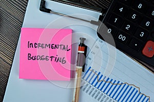 Concept of Incremental Budgeting write on sticky notes isolated on Wooden Table