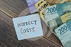 Concept of Indirect Costs write on sticky notes isolated on Wooden Table