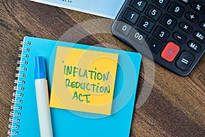 Concept of Inflation Reduction Act write on sticky notes isolated on Wooden Table photo
