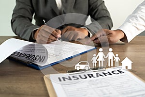 Concept of insurance man protective and car  family  health insurance  policy examining