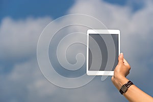 Concept of internet and communication. blank empty tablet computer in the hands of women on the sky