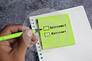 Concept of Introvert or extrovert write on sticky notes  on Wooden Table