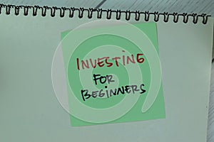 Concept of Investing For Beginners write on a book isolated on Wooden Table