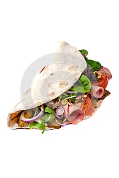 The concept of Italian cuisine. Piadina with ham, tomatoes, lettuce mix, pistachios and cucumbers on white background. Isolate