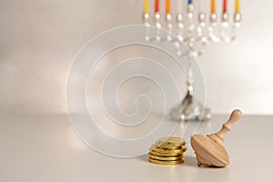 concept of of jewish religious holiday hanukkah with wooden spinning top toy & x28;dreidel& x29; and chocolate coins