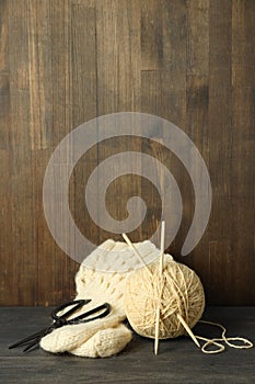 Concept of knitting with yarn ball on gray wooden table