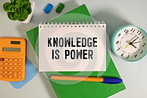 Concept:Knowledge is power written on torn paper with black background and pen