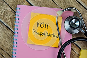 Concept of KOH Preparation write on sticky notes with stethoscope isolated on Wooden Table