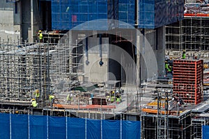 Concept of laborers working on modern construction site