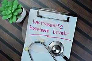 Concept of Lactogenic Hormone Level write on paperwork isolated on Wooden Table