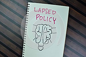 Concept of Lapsed Policy write on a book isolated on Wooden Table