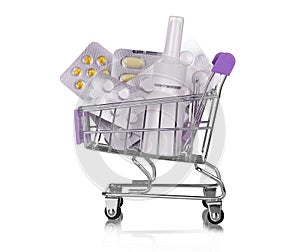 Concept of large spending on medicines. Shopping cart full of medicines and pills isolated on white