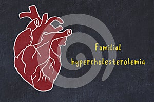 Concept of learning cardiovascular system. Chalk drawing of human heart and inscription Familial hypercholesterolemia