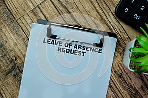 Concept of Leave of Absence Request write on paperwork isolated on Wooden Table