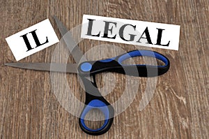 Concept of legality and illegality with a word cut out with scissors