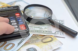 The concept of lending. Money, calculator, magnifier.