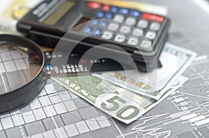 The concept of lending. Money, calculator, magnifier.