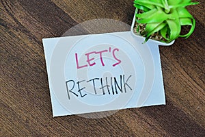 Concept of Let\'s Rethink write on sticky notes isolated on Wooden Table