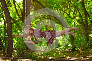 He concept of levitation. The girl flies through the woods