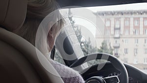 The concept of lifestyle and beauty. Close-up of the charming face of a young blonde driving her car.