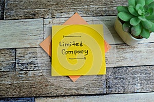 Concept of Limited Company write on sticky notes isolated on Wooden Table