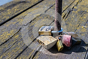 Concept of love, fidelity, . Padlocks on the railing of an ancient wooden bridge of a European city