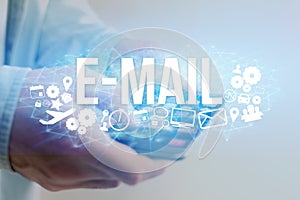 Concept of man holding futuristic interface with e-mail title an