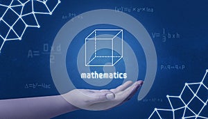 Concept of mathematics. Cube in hand surrounded by mathematical formulas